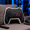 A black and white gamer controller rests on a gray sofa next to a dark blanket.