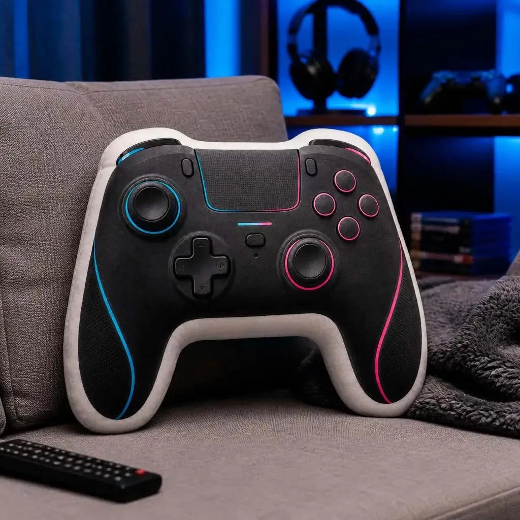 A black and white gamer controller rests on a gray sofa next to a dark blanket.
