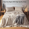 A bed with French stone washed linen bedding set and pillows in neutral tones.