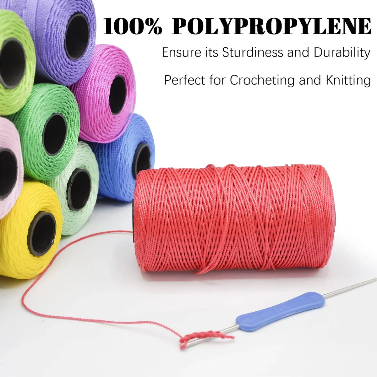 A spool of bright orange polypropylene yarn with a needle attached, used for crocheting and knitting.