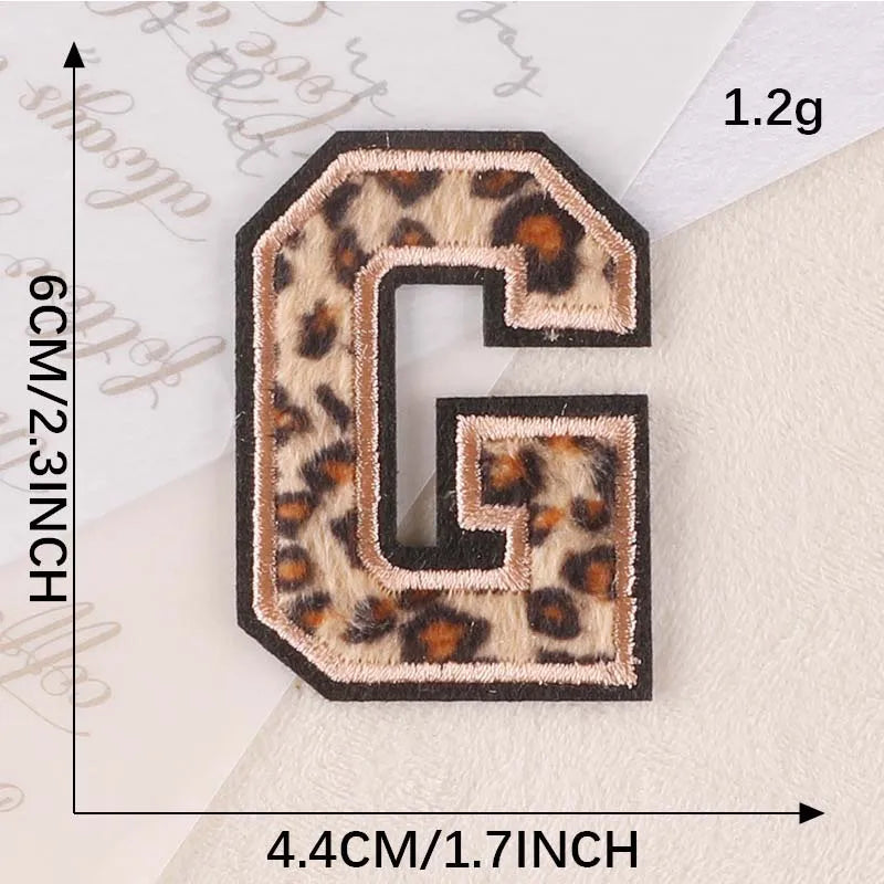 A leopard print alphabet iron-on patch shaped like the letter G, measuring 1.2 grams.