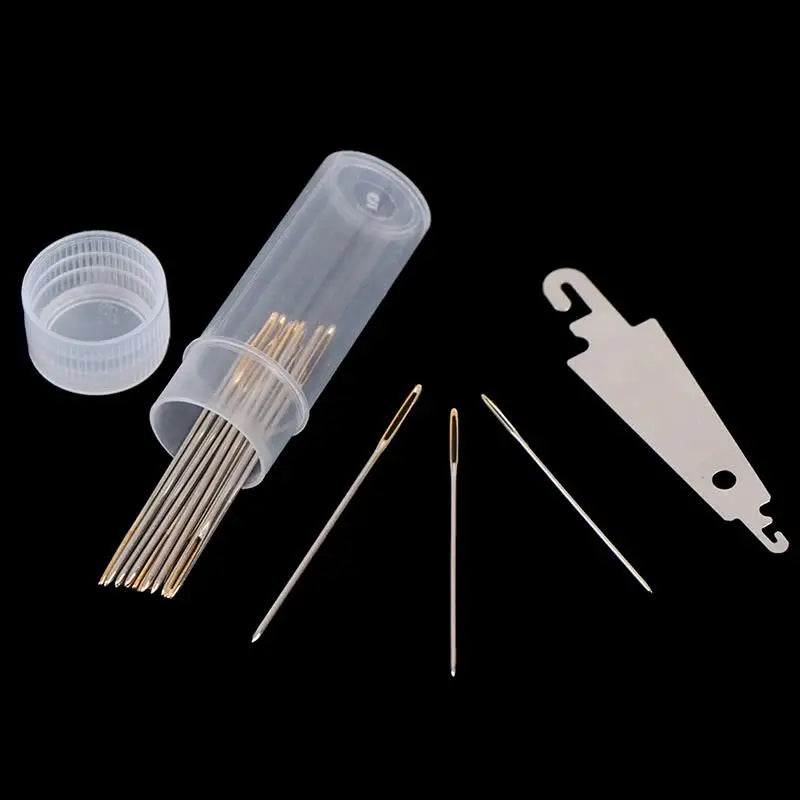 A set of gold eye embroidery and hand sewing needles in a clear plastic container and on a white card.