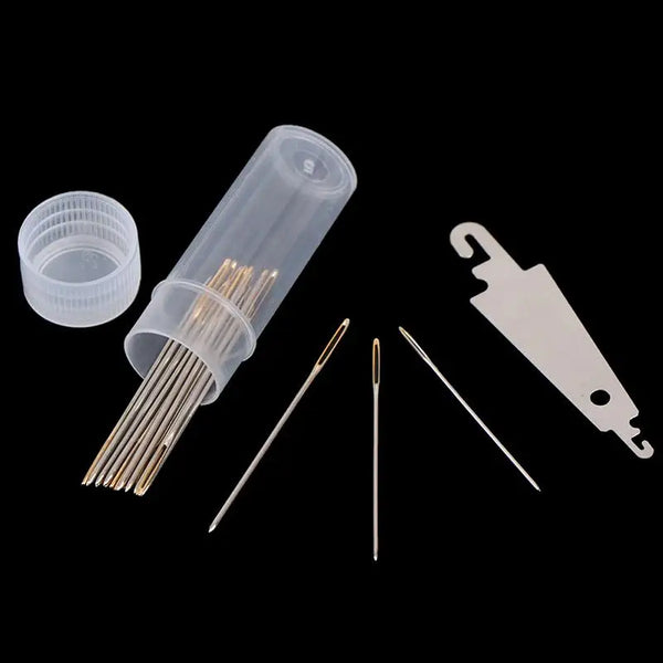 A set of gold eye embroidery and hand sewing needles in a clear plastic container and on a white card.