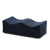A dark blue ergonomic memory foam leg support pillow.