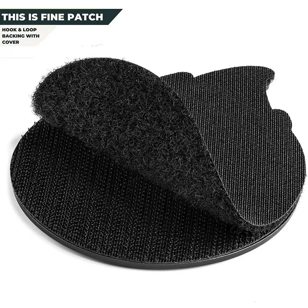 A black felt patch with a hook and loop backing and a cover is shown on a black surface.