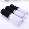 Rolls of black and white adjustable elastic bands for garments