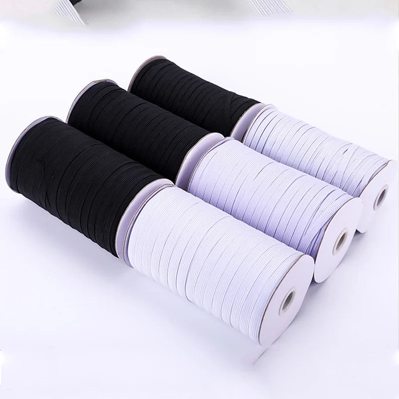Rolls of black and white adjustable elastic bands for garments