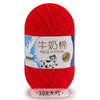 A ball of bright red milk cotton yarn labeled with Chinese and English text.