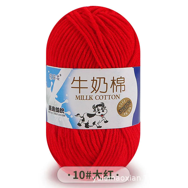 A ball of bright red milk cotton yarn labeled with Chinese and English text.