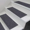 White staircase with dark gray self-adhesive mats on the steps