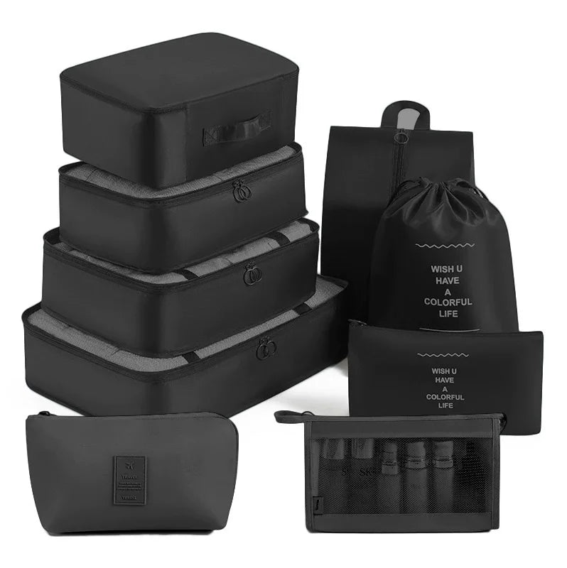 A set of black travel storage organizers including multiple zippered pouches and a flat organizer case.