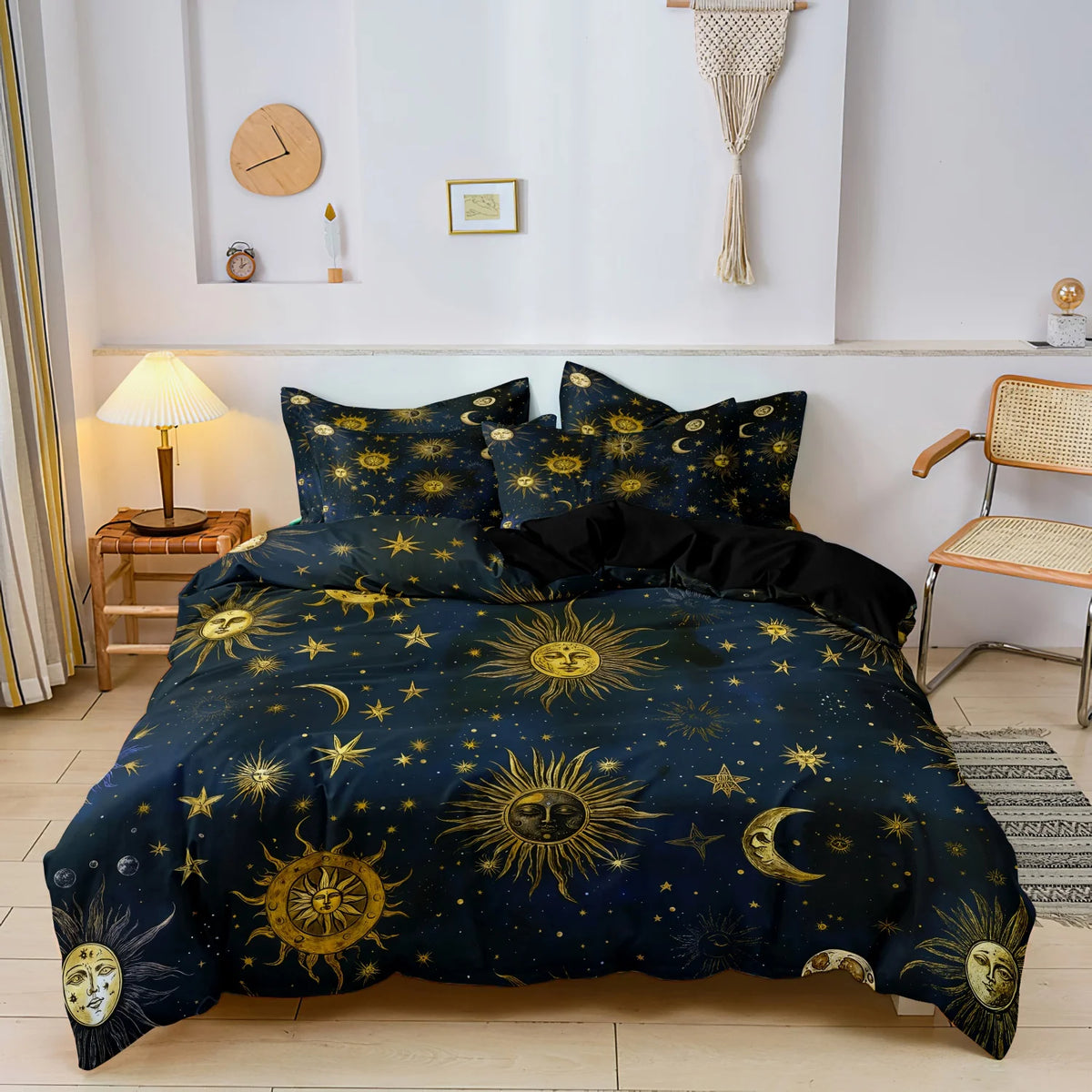 A dark blue duvet set featuring a sun and moon pattern with gold accents, displayed on a bed.