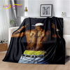 A black throw blanket featuring a vintage-inspired graphic of a man with tattoos and gold jewelry.