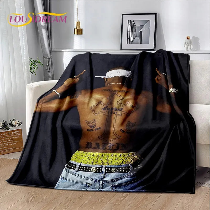 A black throw blanket featuring a vintage-inspired graphic of a man with tattoos and gold jewelry.