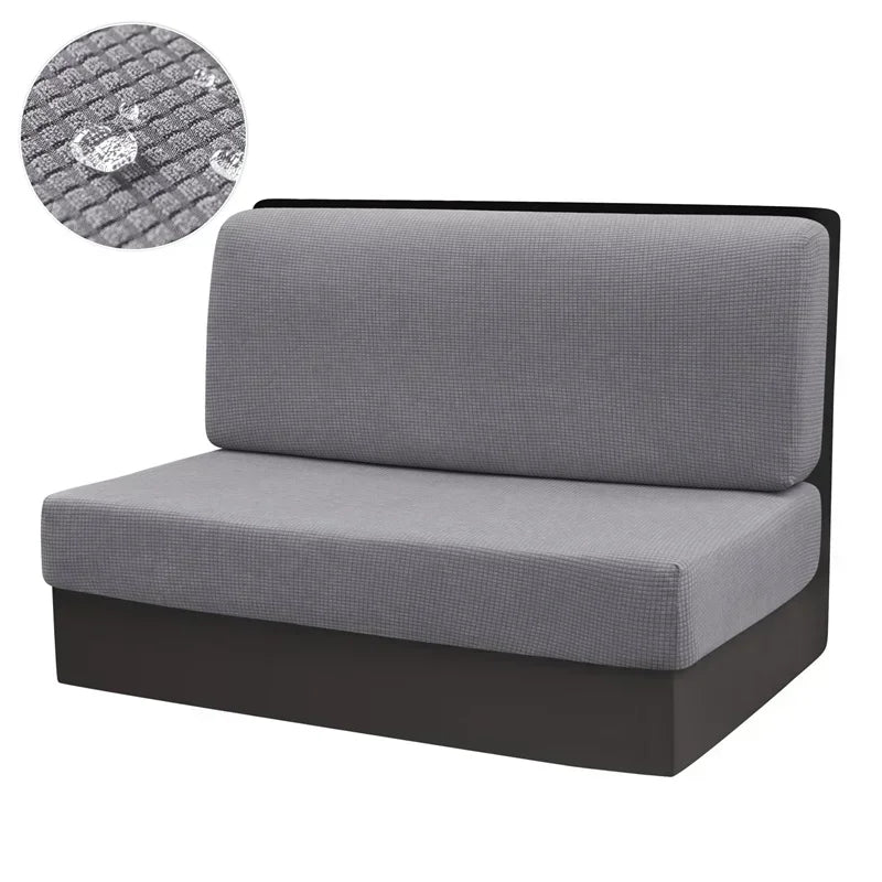 A gray water repellent stretch sofa and chair cover with a textured fabric detail.