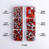 A collection of orange glass rhinestones in various sizes and colors packaged in clear compartments.