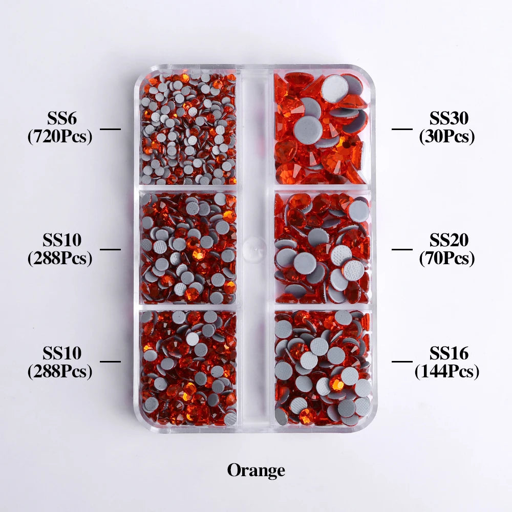 A collection of orange glass rhinestones in various sizes and colors packaged in clear compartments.