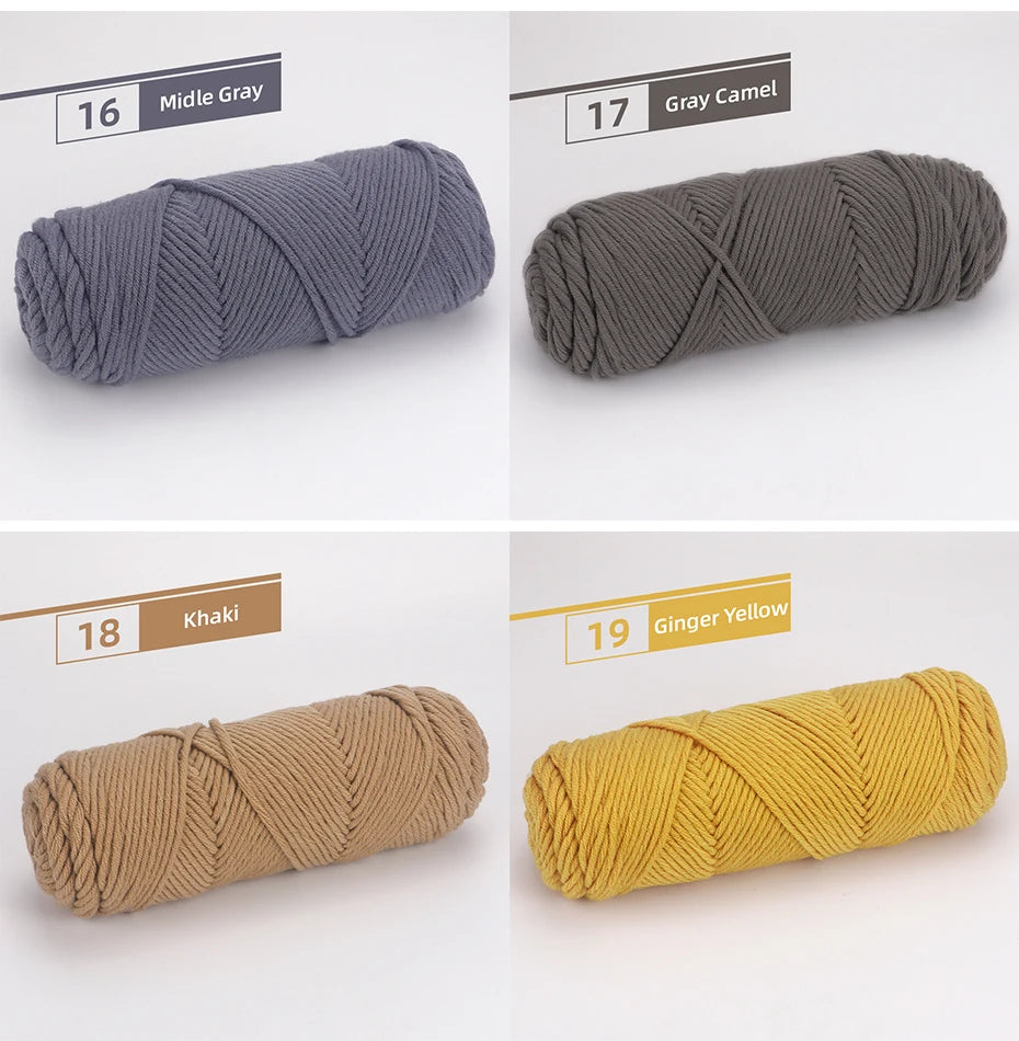 A collection of four skeins of premium worsted cotton yarn in shades of gray, camel, khaki, and ginger yellow.