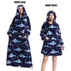 A woman models a navy blue and purple patterned plush fleece blanket hoodie for adults.