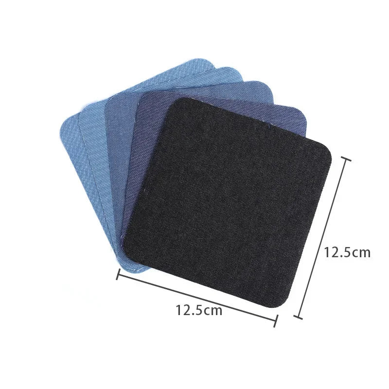 A stack of iron-on cotton patches in various shades of blue and black.