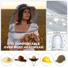 A woman wearing an extra large mosquito net with a face mask in a field setting, demonstrating effective protection.