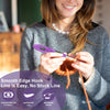 A woman holds a purple crochet hook with an LED and stitch counter against a gray sweater.