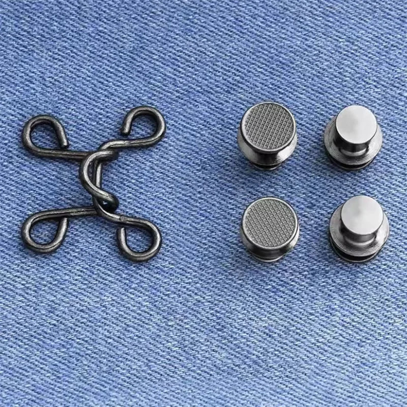 A set of metal button snaps in silver finish, including a scissor-style opener and several round snaps.