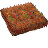 An orange and red bohemian cotton linen throw cushion with decorative fringe.