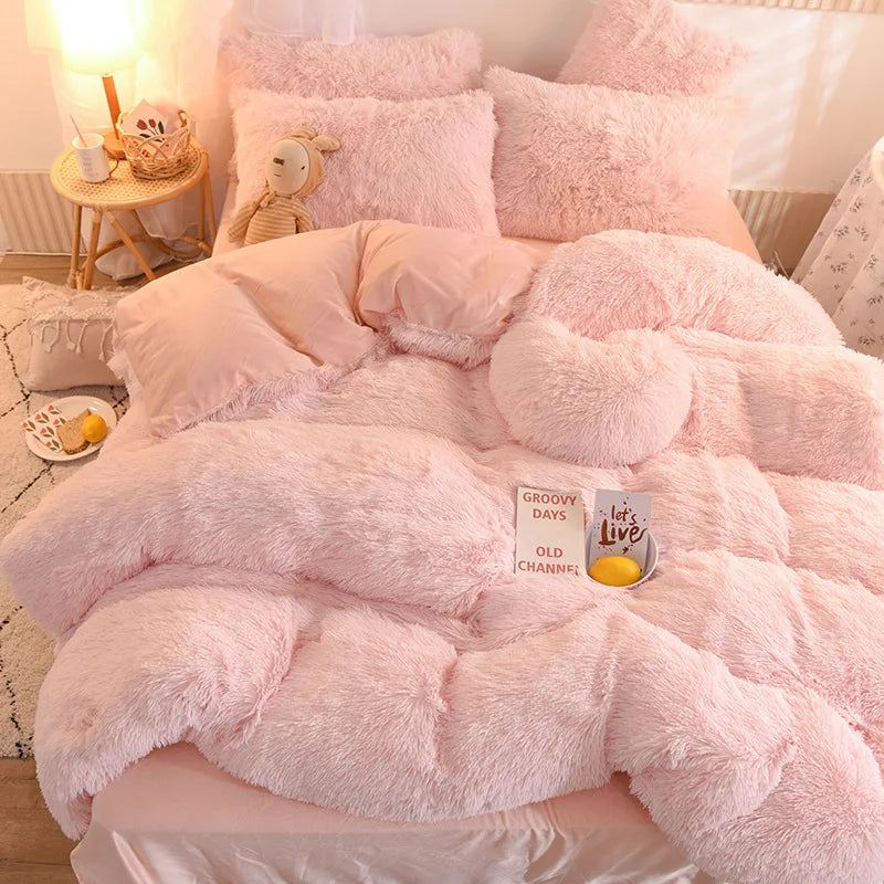 A pink plush mink velvet duvet set with fluffy pink pillows and a small yellow accent.