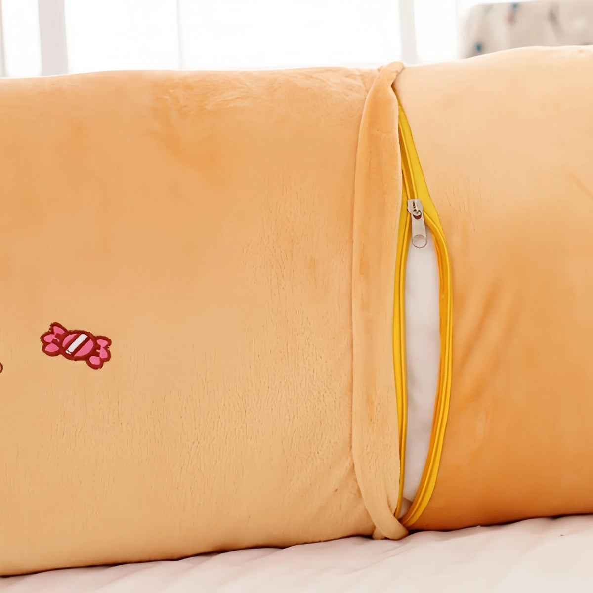 A fluffy orange Rilakkuma plush bed pillow and sofa cushion with a zipper detail.