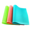 A set of four brightly colored, non-slip silicone shelf liners in lime green, coral, and cyan are displayed.