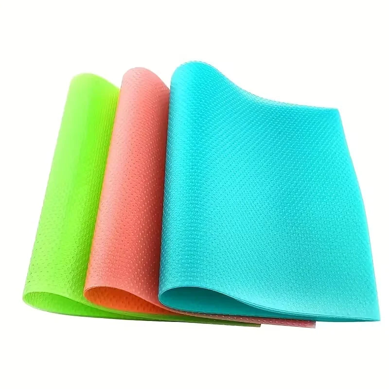 A set of four brightly colored, non-slip silicone shelf liners in lime green, coral, and cyan are displayed.