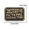 Black iron-on embroidery patch with yellow text that reads Emotionally Attached to Fictional Characters