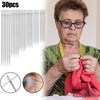 A woman is using a set of 30 stainless steel sewing needles to sew fabric.