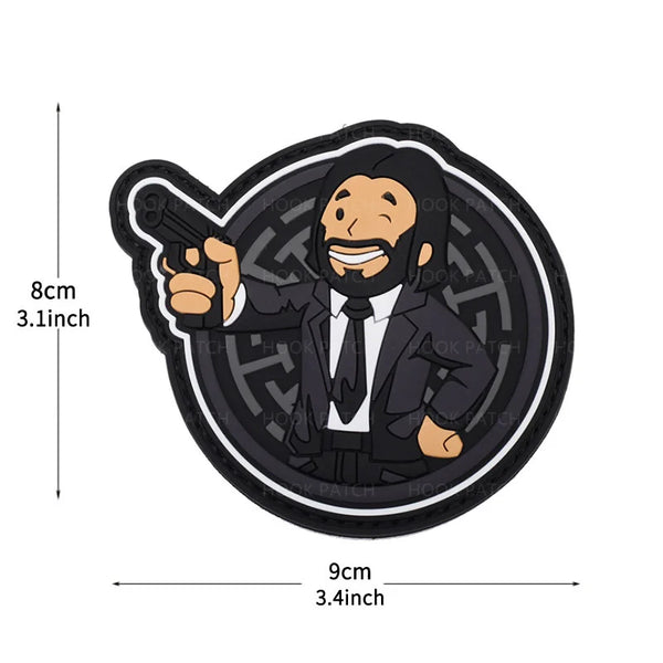 A black embroidered patch featuring a man with a beard pointing a gun.