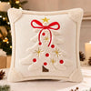 Cream embroidered velvet pillow cover shaped like a Christmas tree with a red bow and gold accents