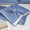 Light blue ice silk cooling quilt folded on a white surface.