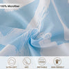 Light blue microfiber fabric with white heart print pattern folded to show texture and softness features