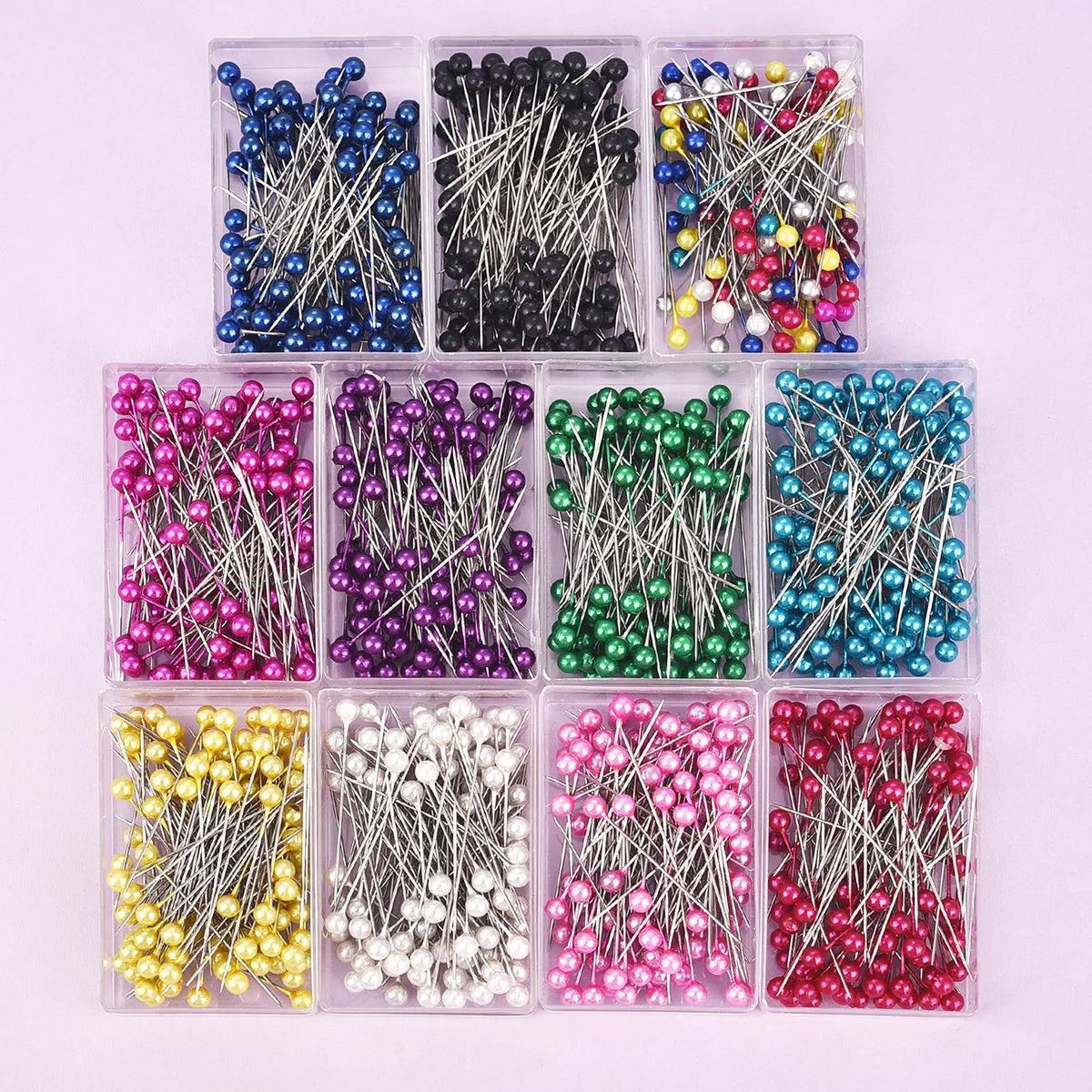 A collection of 100 colorful pearl head sewing pins in various colors and styles for dressmaking and DIY projects.