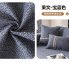 A close-up of a dark gray textured linen fabric used as a sofa cover, displayed in a living room setting.