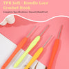 A set of three orange and yellow plastic crochet hooks displayed on a pink background.