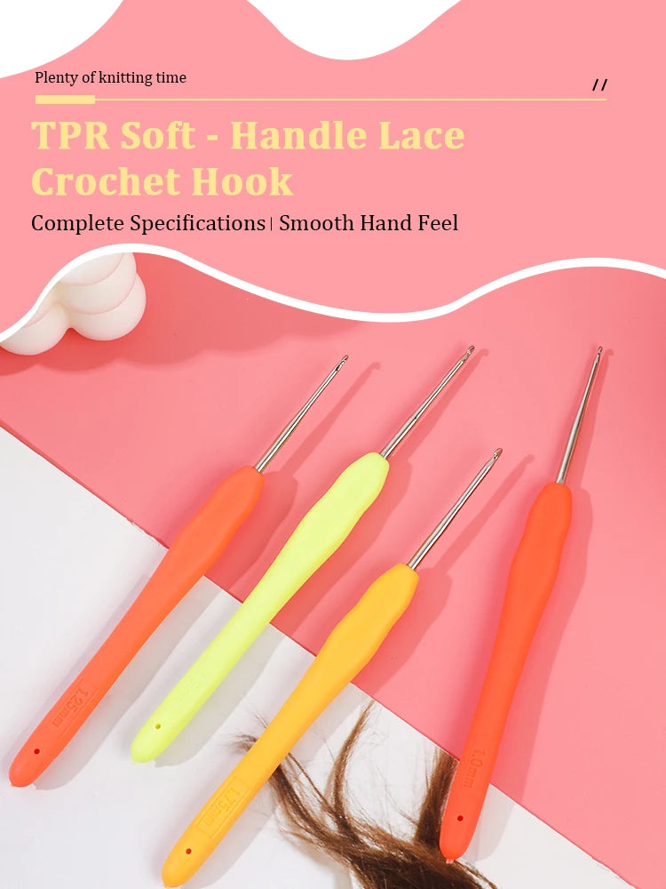 A set of three orange and yellow plastic crochet hooks displayed on a pink background.