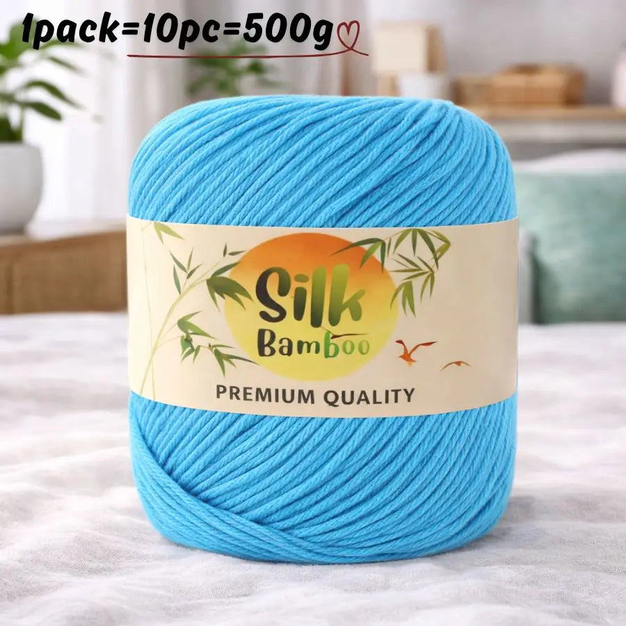 A skein of bright blue silk bamboo blend yarn is shown on a white surface.
