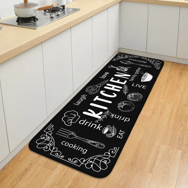 Black floor mat with white text featuring kitchen and bathroom themes like love laugh drink cook and live