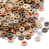 A close-up view of small, round acrylic flat spacer beads in various gold and silver colors.