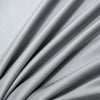 Soft gray luxury bamboo flat sheets draped and folded, showing fabric texture.