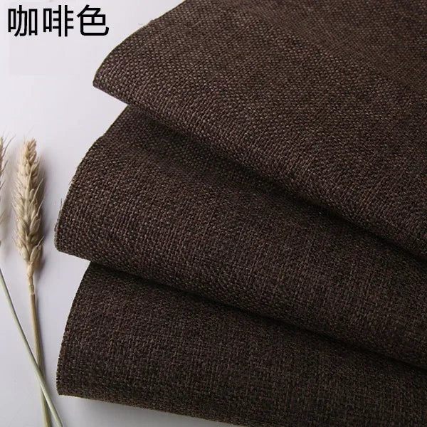 Stack of dark brown coarse linen or cotton fabric rolls