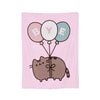 A pink throw blanket featuring a graphic of a cat and three balloons spelling out BYE