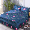 Navy blue fitted bed sheets with a pink flamingo floral pattern and elastic lace trim