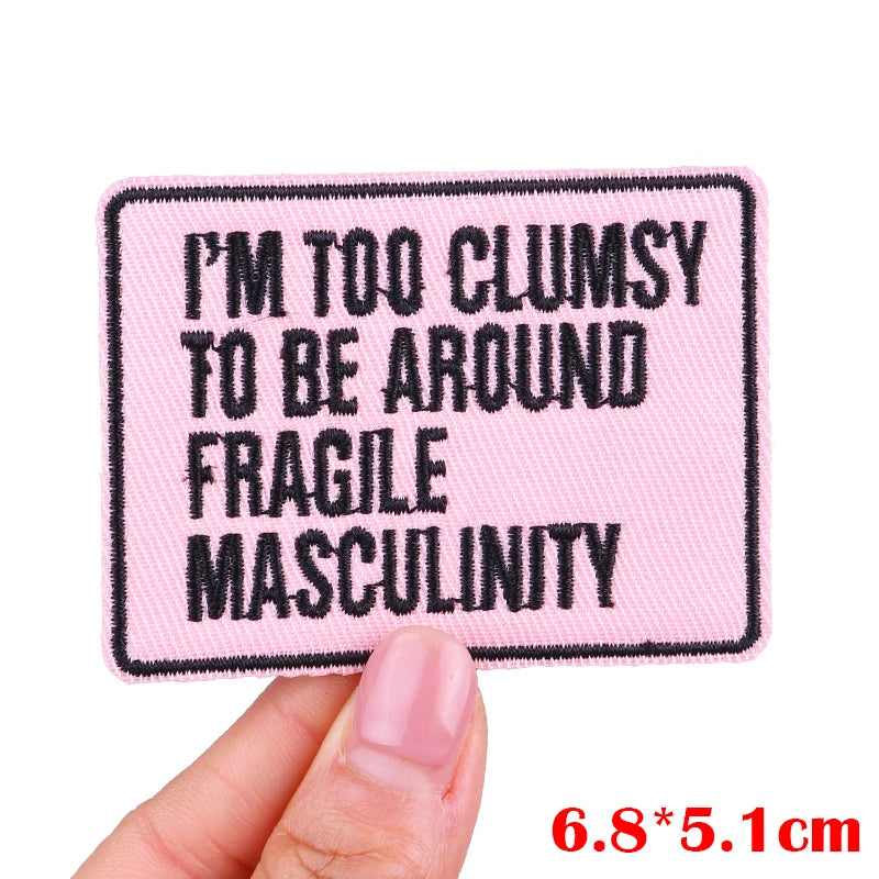 Pink embroidered patch with black text saying I'm too clumsy to be around fragile masculinity